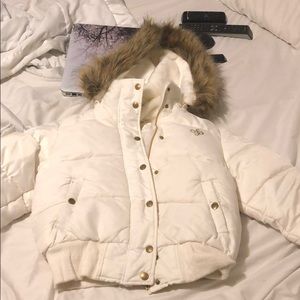 A white South Pole jacket with a fur hood
